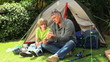 Father and son preparing a fishing rod