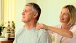 Woman massaging her husband's shoulders
