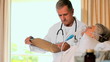 Mature doctor visiting an unconscious patient at the hospital