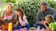 Family picnicking in the garden