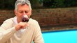 Mature man enjoying a glass of red wine