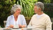 Mature couple having coffee in the garden