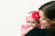 proud young mother holding baby