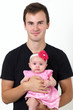 Proud father holding his infant daughter