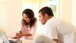 Woman showing something on her laptop to her boyfriend 