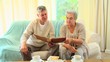 Video: Mature couple looking at an album Mature couple looking at an album