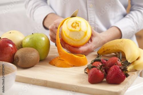 Photo: Woman peeling orange Woman peeling orange