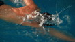 Sporty guy swimming in water