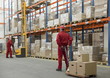 Photo: workers in uniforms and safety helmets working in storehouse workers in uniforms and safety helmets working in storehouse