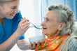 senior woman 90 years old being fed by a nurse senior woman 90 years old being fed by a nurse