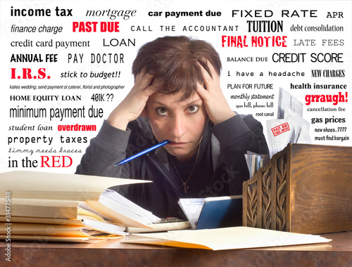 Photo: Woman Overwhelmed While Paying Bills Woman Overwhelmed While Paying Bills