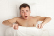 Photo: surprised young handsome man in white bedding, series surprised young handsome man in white bedding, series