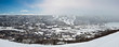 Panoramic view of small city in the valley with winter mountain
