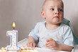 Little baby celebrating its first birthday, in front of him cake Little baby celebrating its first birthday, in front of him cake