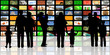 young people with children watching television on huge lcd panel