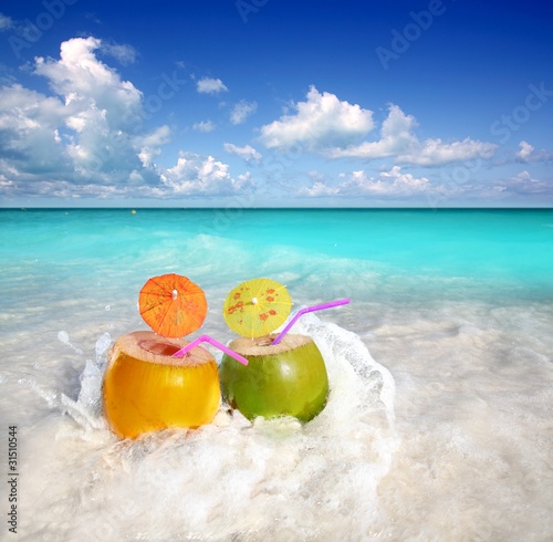 Photo: coconut cocktails juice in tropical beach water splash coconut cocktails juice in tropical beach water splash
