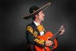 Charro Mariachi playing guitar on black Charro Mariachi playing guitar on black