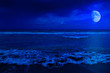 Night scene in a deserted beach with a crescent moon