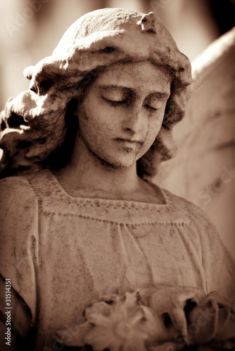 Photo : Weathered young angel in sepia tones Weathered young angel in sepia tones