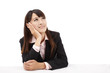 Asian Business woman looks upward and thinks . Asian Business woman looks upward and thinks .