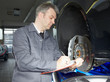 Master mechanic in a garage is writing an order