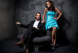 Handsome man ironing attractive brunette