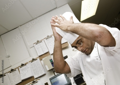 Photo: Chef Putting Hat On Chef Putting Hat On