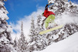 Foto: Snowboarder jumping through air with blue sky in background Snowboarder jumping through air with blue sky in background