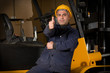 Forklift operator giving okay sign at warehouse.