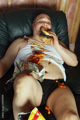 Photo: Couch potato eating and watching TV Couch potato eating and watching TV