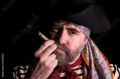 Photo: Pirate smoking a cigar. Pirate smoking a cigar.