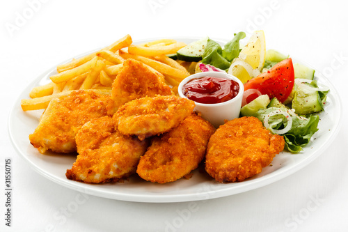 Photo: Fried chicken nuggets, French fries and vegetables Fried chicken nuggets, French fries and vegetables