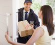 Delivery man handing box to woman