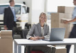 Supervisor working on laptop in shipping area