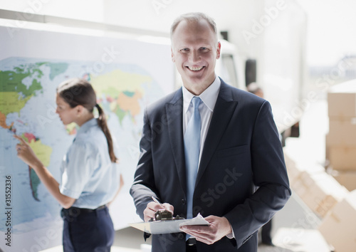 Photo: Supervisor holding clipboard in shipping area Supervisor holding clipboard in shipping area