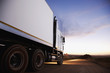 Semi-truck driving on dirt road