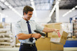 Worker scanning box in shipping area