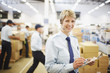 Worker with clipboard in shipping area