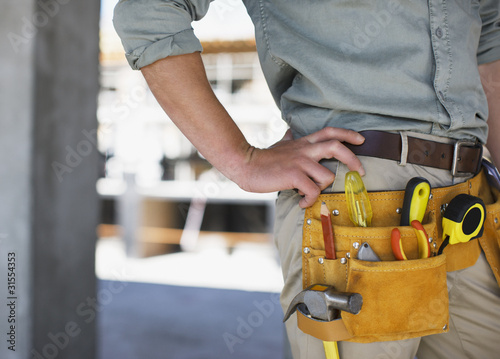 Photo: Close up of construction worker?s tool belt on construction site Close up of construction worker?s tool belt on construction site