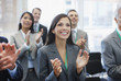 Business people clapping in seminar