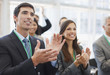 Business people clapping at seminar in office