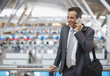 Businessman talking on cell phone in airport