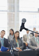 Business people attending seminar in office