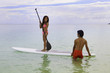 hawaiian beachboy teaches young woman to paddleboard hawaiian beachboy teaches young woman to paddleboard