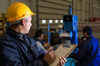 Inspector checking workers at factory.