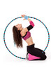 Fitness teacher posing in hula hoop