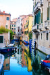 Venice canal with boats and colored houses, Italy Venice canal with boats and colored houses, Italy