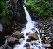 First waterfall in gorge Ayu-Say and flow of water on stone First waterfall in gorge Ayu-Say and flow of water on stone