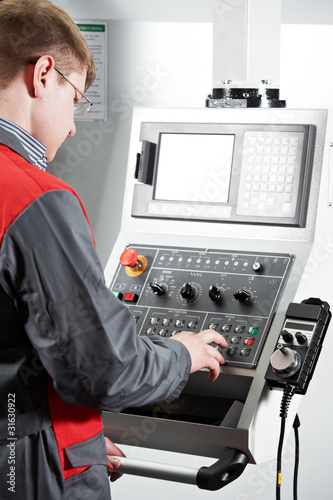 Photo: worker at machining tool workshop worker at machining tool workshop