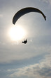 Paraglider with rising sun in background